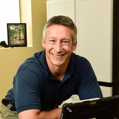 Headshot of Jason Burtchell at a computer